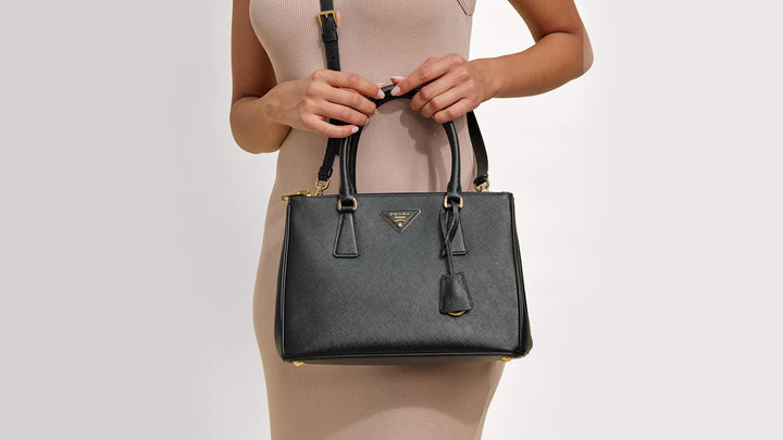 Cropped image of a model holding a Prada Galleria Bag