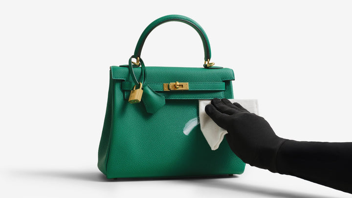 A hand cleaning a Birkin using the ReNew Handbag Cleaning Kit