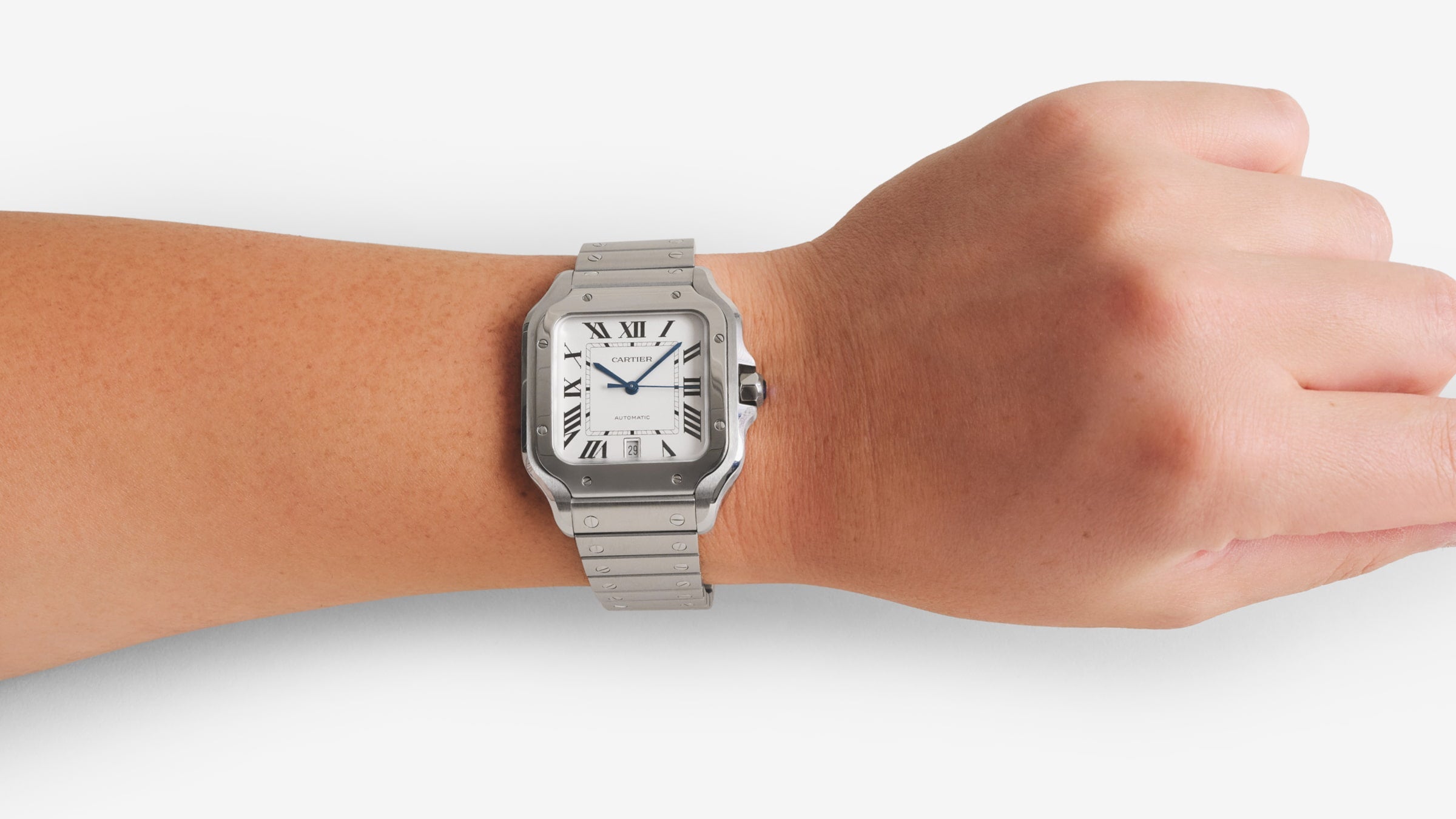 Outstretched arm with a Cartier watch on the wrist