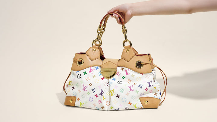 Hand holding an LVxTM Ursula bag in Multicolor