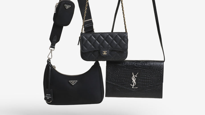 Black Prada, Chanel, and Saint Laurent bags suspended from the straps