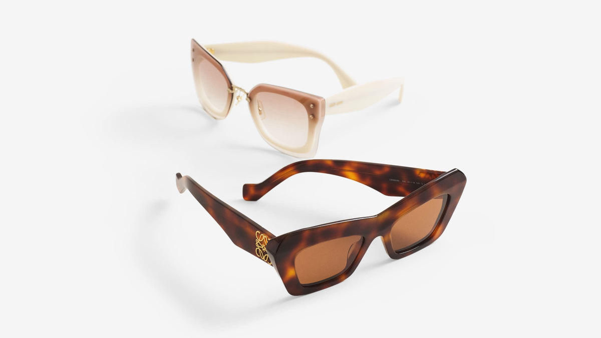 Two designer sunglasses side by side