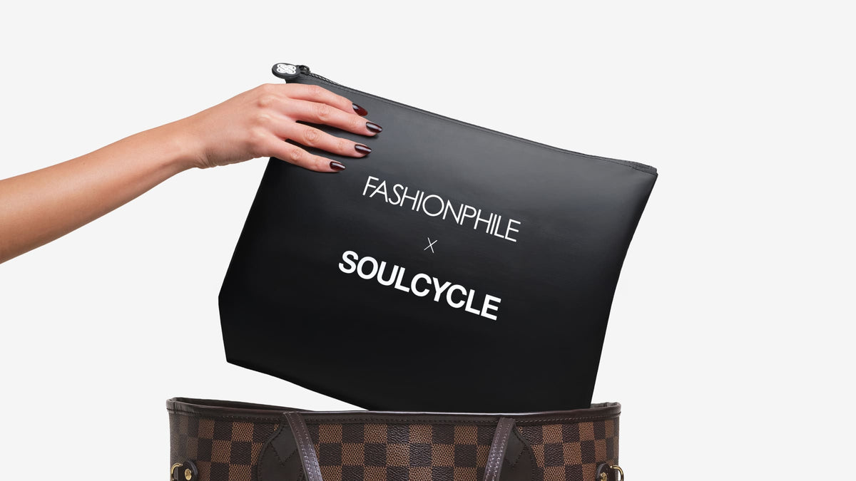 FASHIONPHILE x SoulCycle Sweat Bag being pulled out of a Louis Vuitton Neverfull