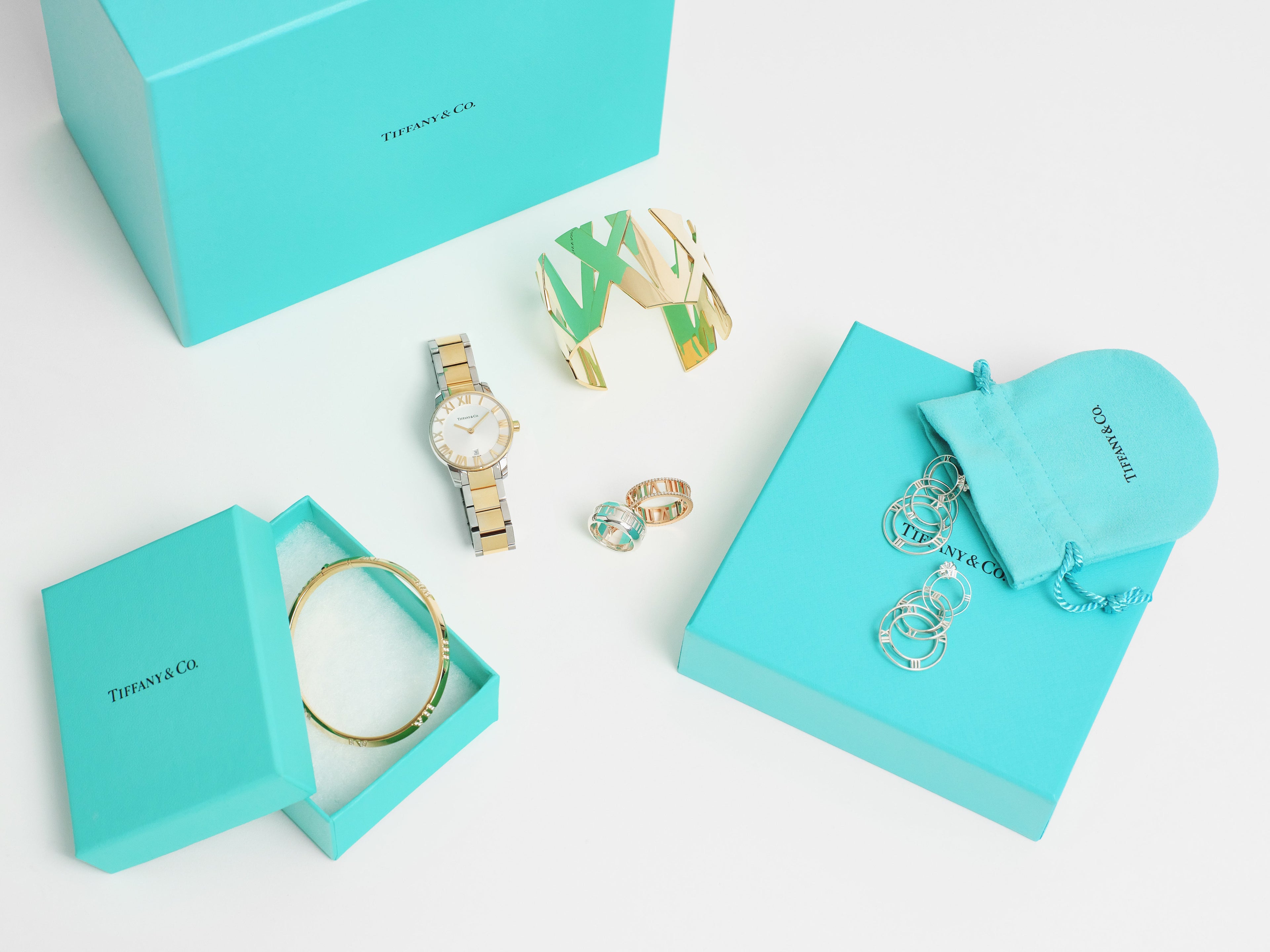 Flat lay pieces from Tiffany & Co.’s Atlas Jewelry Collection surrounded by the original packaging