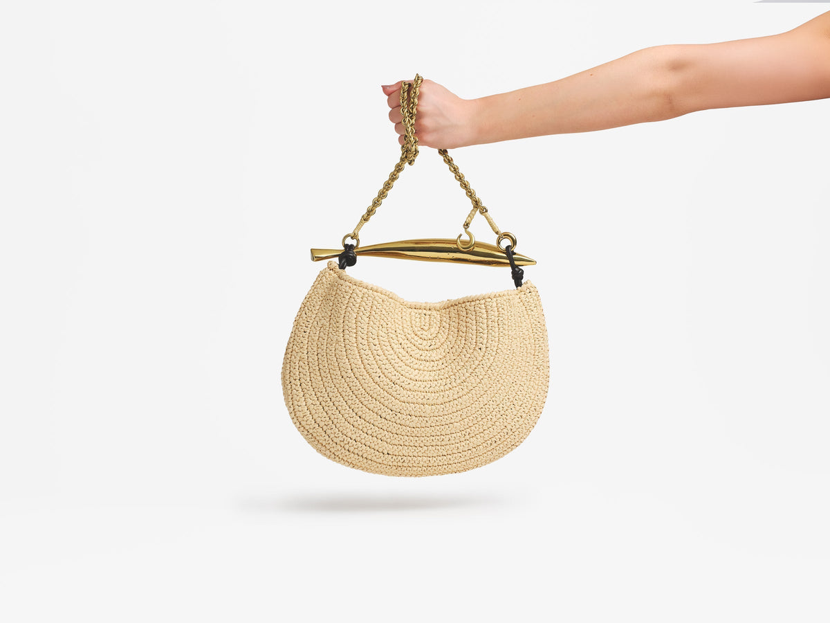 Hand holding a Bottega Veneta Sardine bag