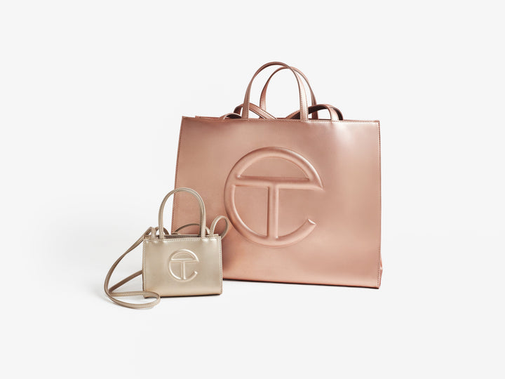 Two Telfar Shopping Bags, one large and one small, facing the camera at an angle to each other.