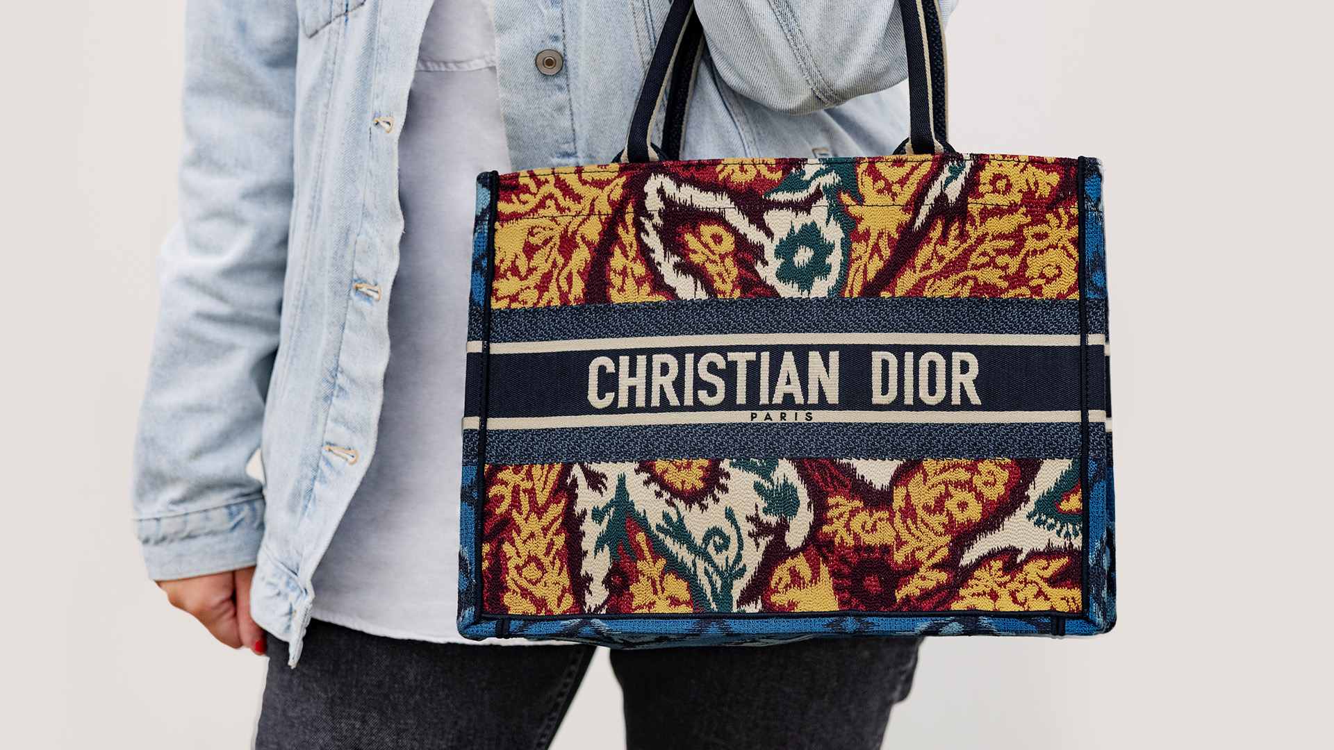 lifestyle image of paisley christian dior book tote FASHIONPHILE