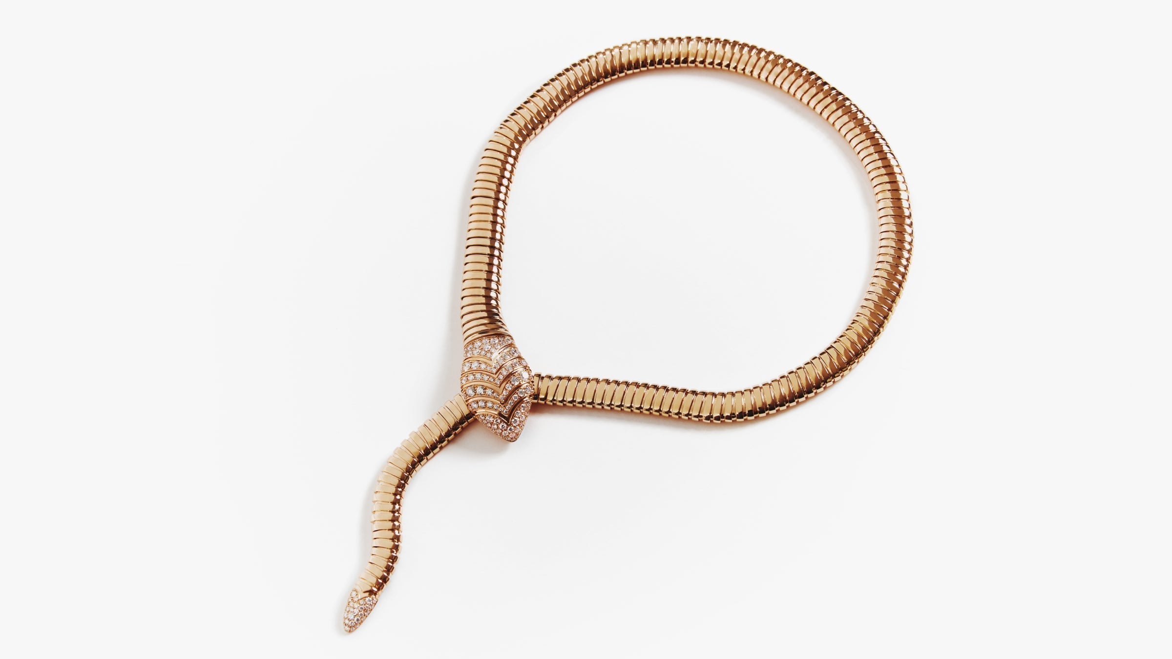 Yellow gold Serpenti necklace against a white background
