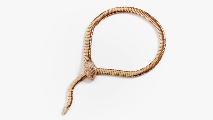 Yellow gold Serpenti necklace against a white background