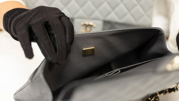image of brand authenticator checking Chanel microchip FASHIONPHILE