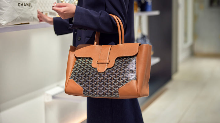 the new goyard saigon tote in black and gold worn on the arm by FASHIONPHILE