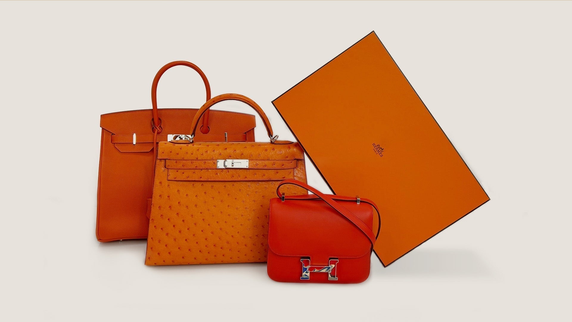 studio image of hermes orange bags and orange box FASHIONPHILE
