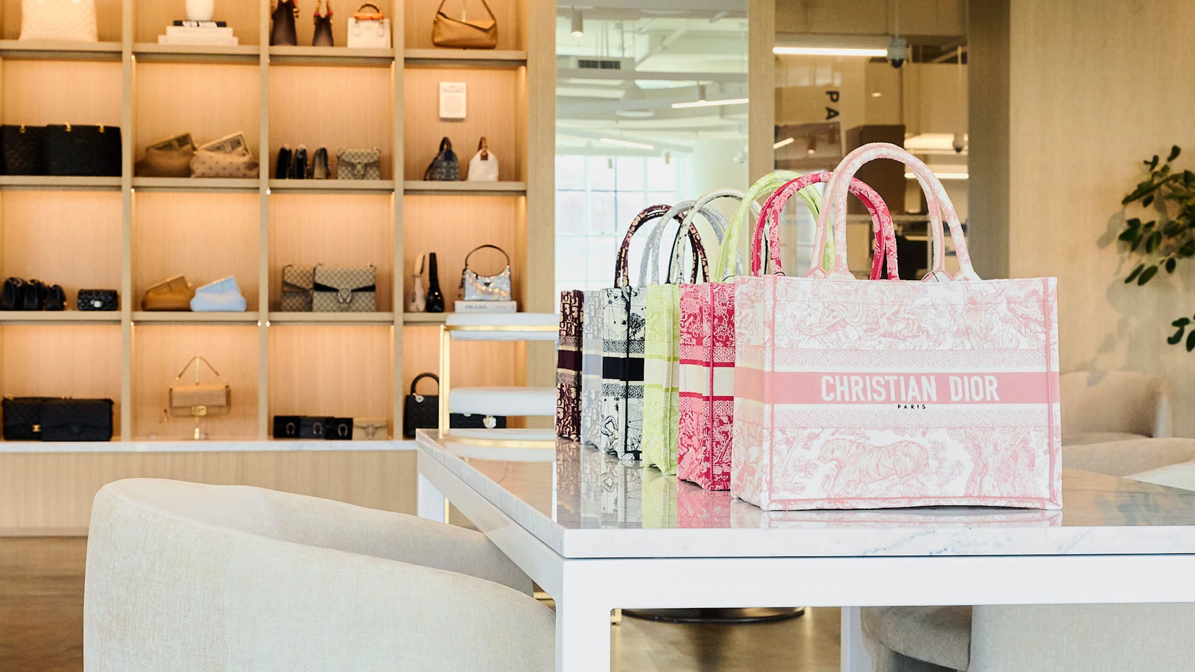 Multicolor Dior book totes lined up on the table in the FASHIONPHILE New York City Flagship