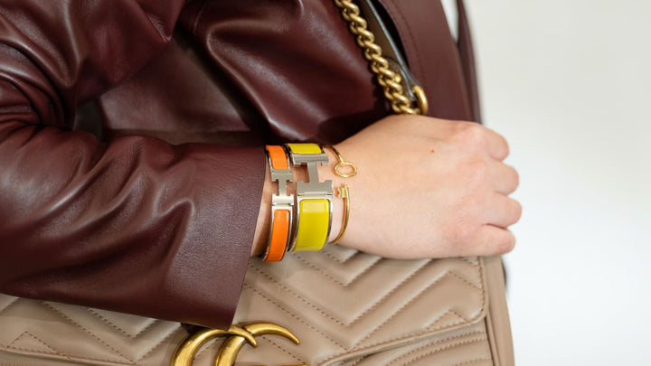 styling a stack with an hermes clic h bracelet, an hermes clic clac h bracelet and a tiffany bracelet by FASHIONPHILE