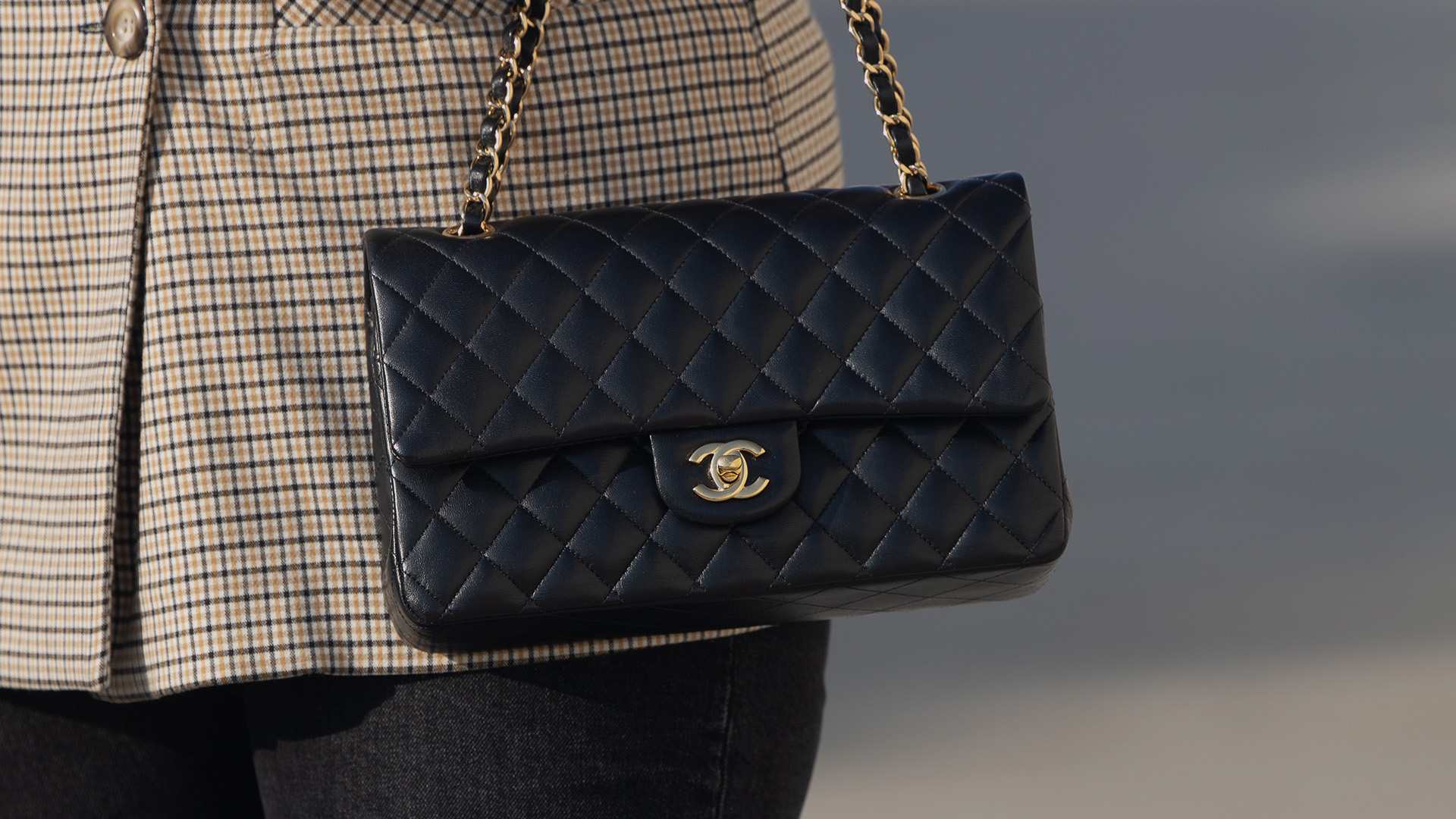 lifestyle image of model wearing chanel flap bag FASHIONPHILE