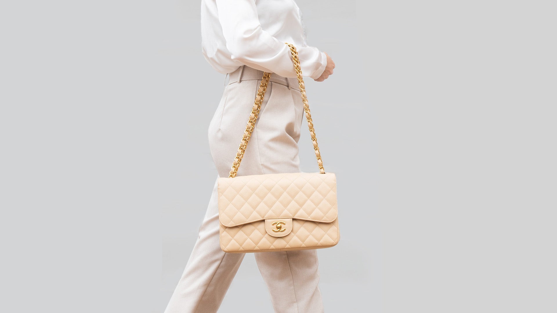 lifestyle image of model wearing beige chanel caviar flap FASHIONPHILE