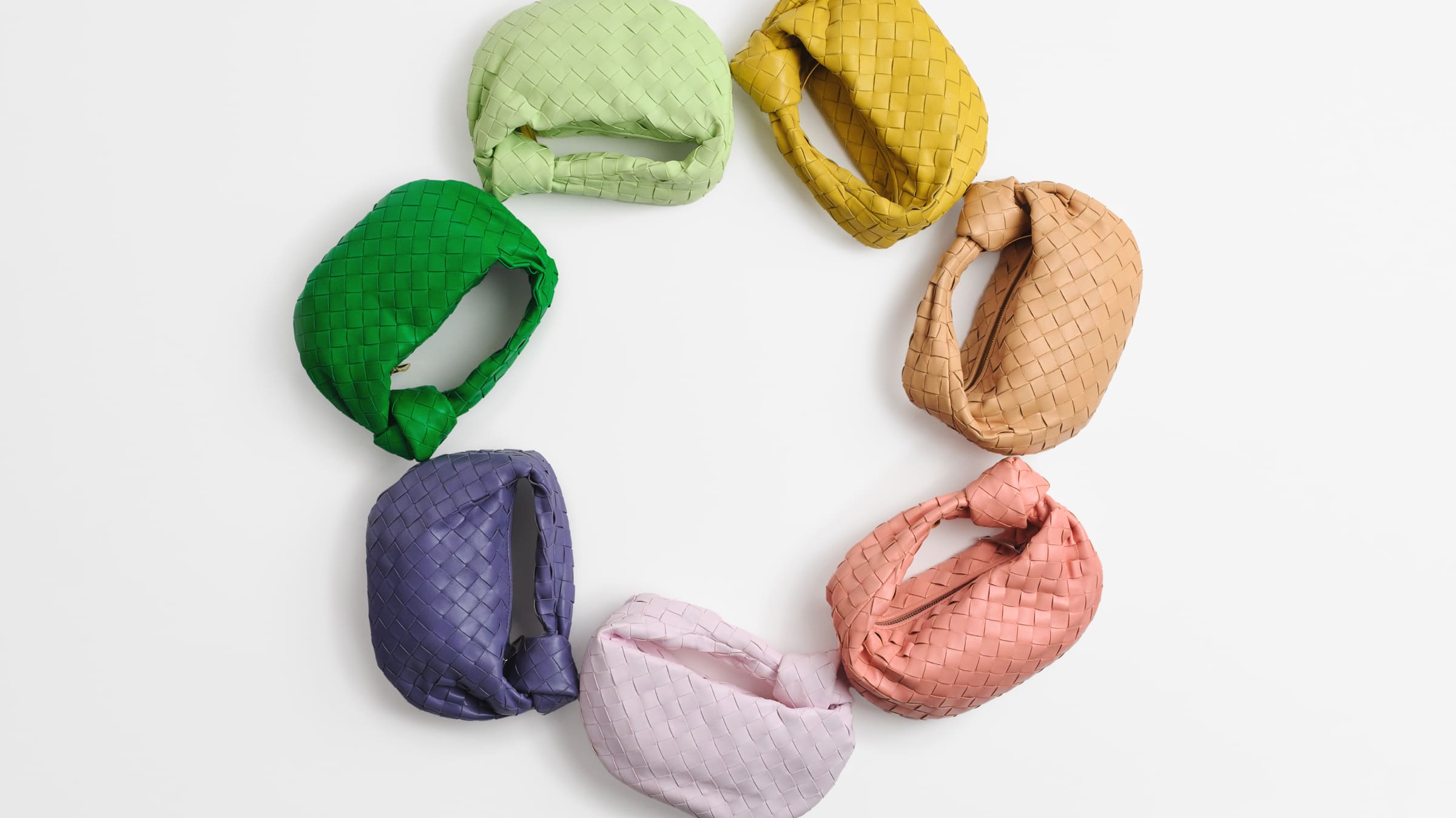 A pinwheel of Bottega Veneta Jodie bags in different colors ranging from green to purple