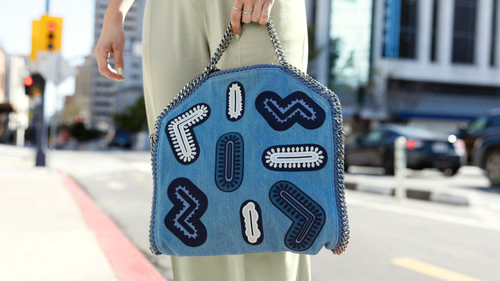 lifestyle image of model wearing a denim patched stella mccartney falabella bag downtown FASHIONPHILE