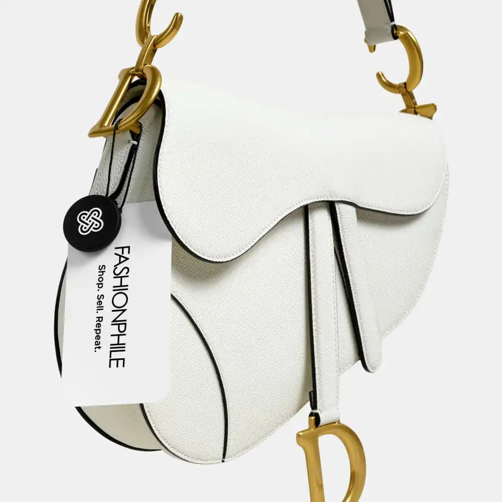 A white Christian Dior Saddle Bag with a FASHIONPHILE tag