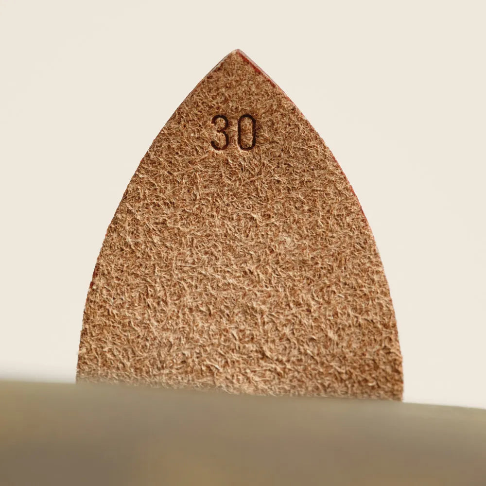 The underside of a leaf tab on a Louis Vuitton Speedy with the number 30 blindly embossed.