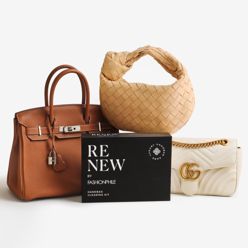 ReNew Handbag Cleaning Kit surrounded by an Hermes Birkin, a Bottega Veneta Jodie, and a Gucci Marmont.
