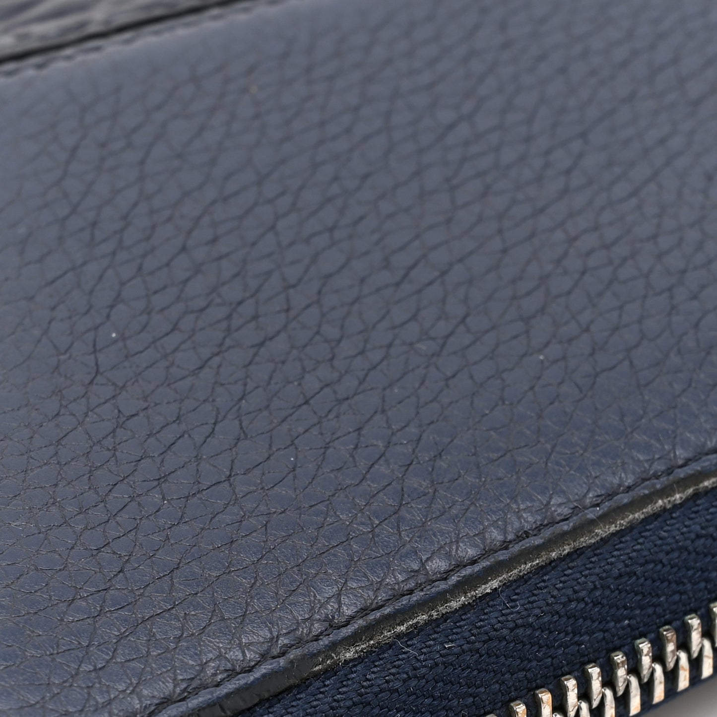 Calfskin Embossed Repeat Puzzle Zip Around Wallet Blue