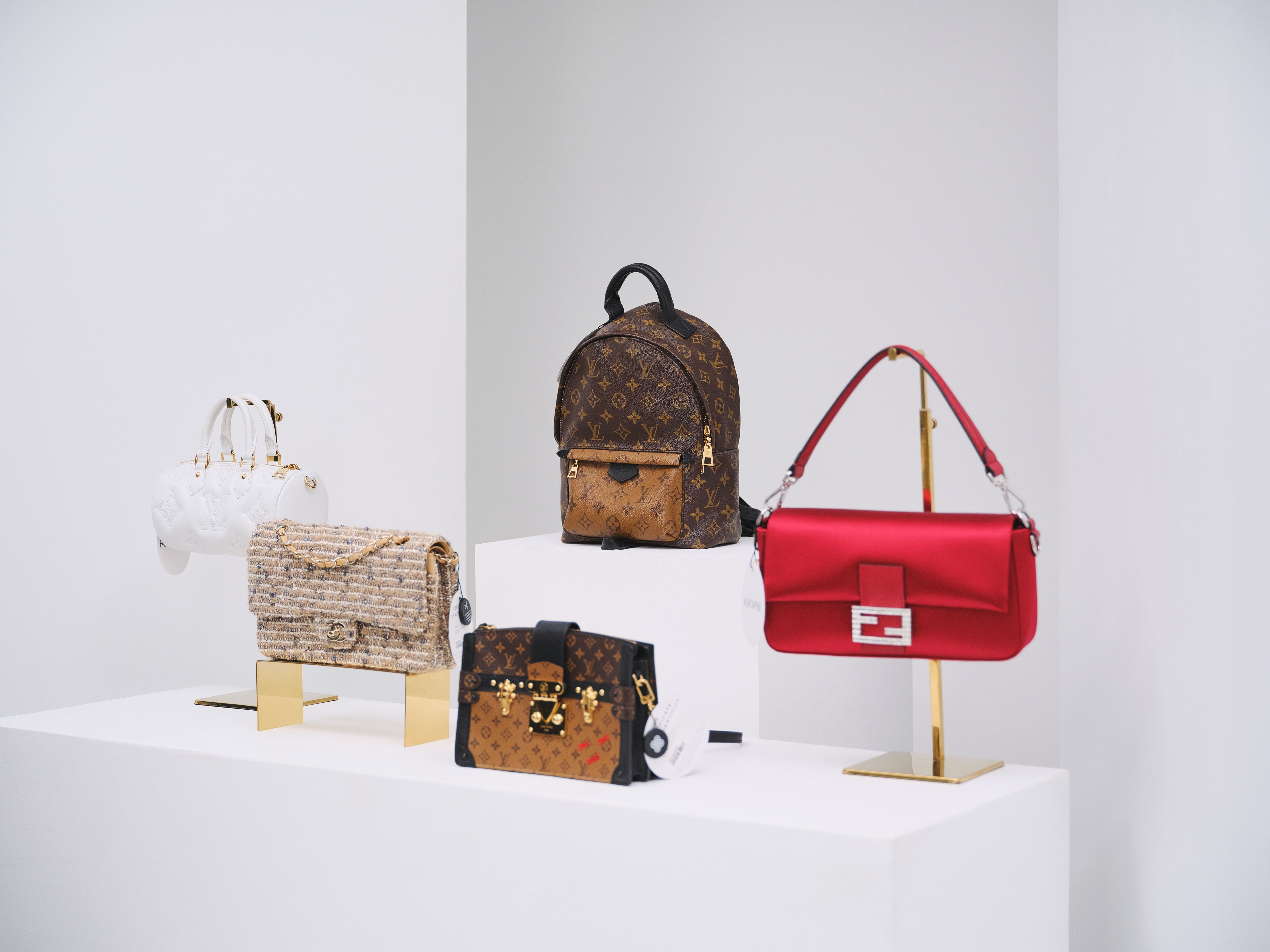 A lineup of luxury bags on display, including Chanel, Louis Vuitton, and Fendi for Live Shopping with FASHIONPHILE.