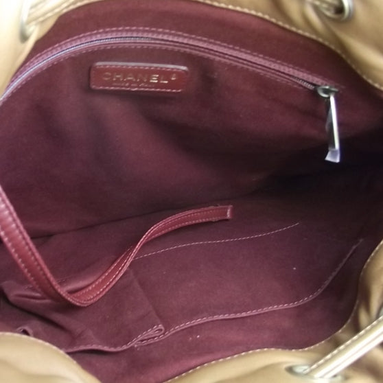 Leather Camellia Embossed Drawstring Shoulder Bag