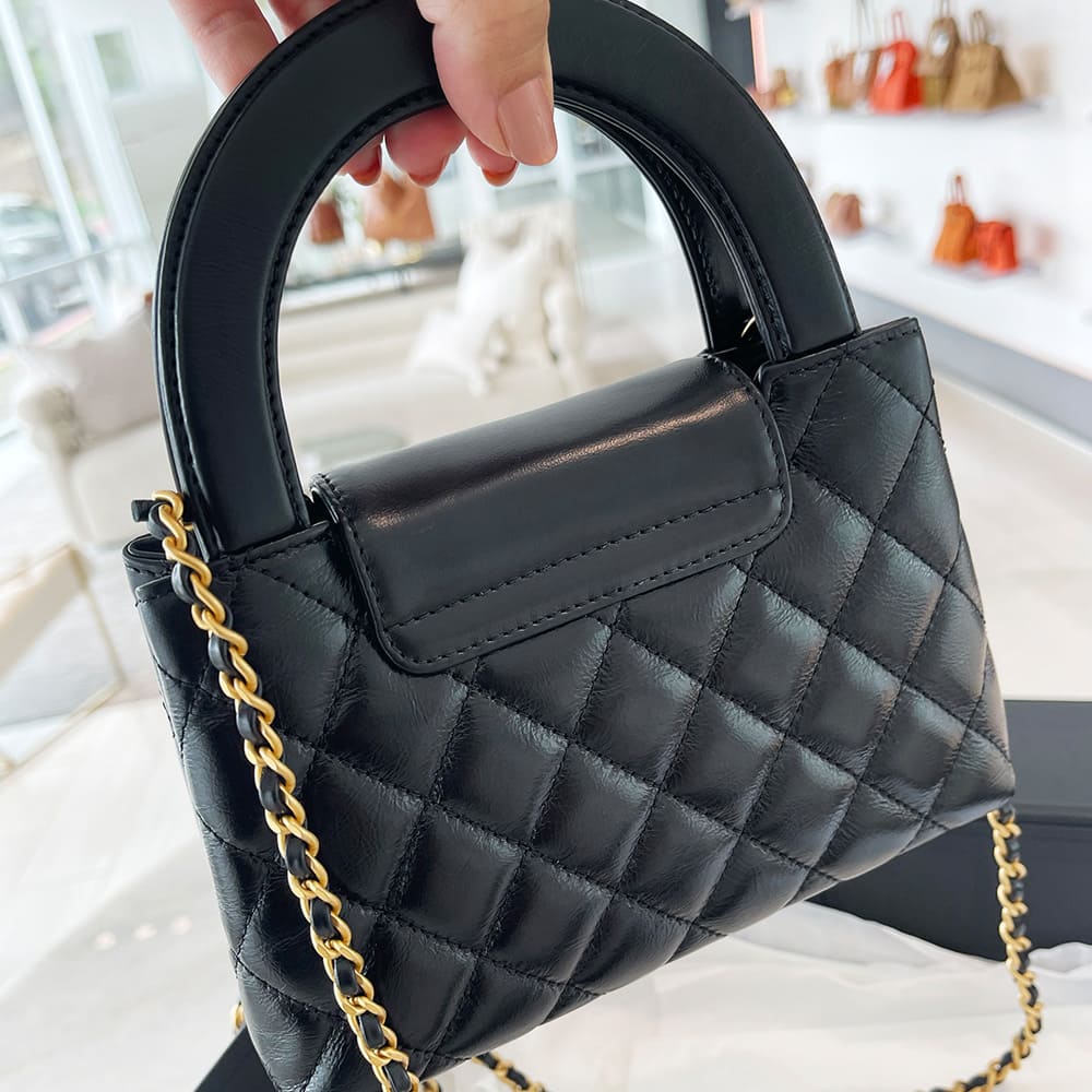 back view image of a black chanel nano kelly shopper bag by FASHIONPHILE