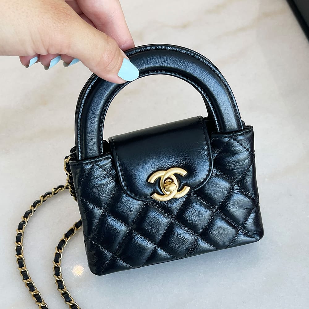 front view image of a black chanel mini nano kelly shopper bag by FASHIONPHILE