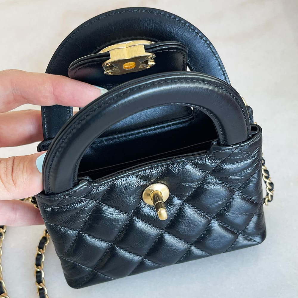 an image of a black chanel mini nano kelly shopper bag opened by FASHIONPHILE
