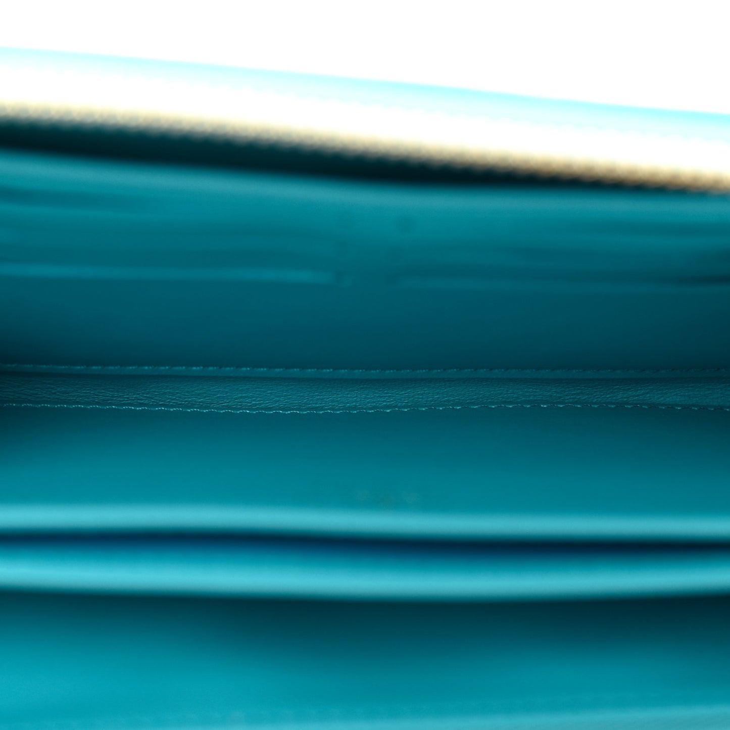 Lambskin Embossed Monogram Coussin Zippy Wallet Turquoise