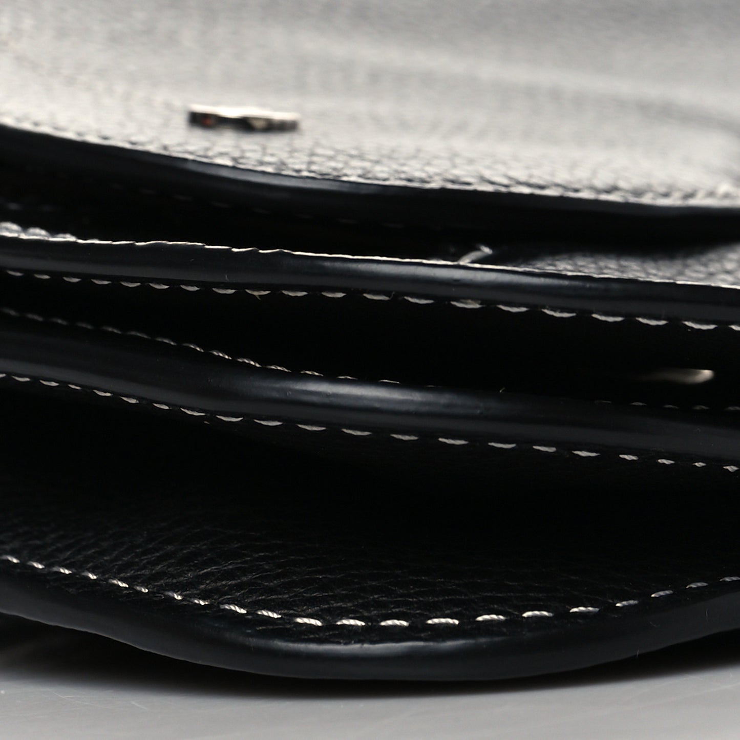 X KAWS Grained Calfskin Saddle Wristlet Black