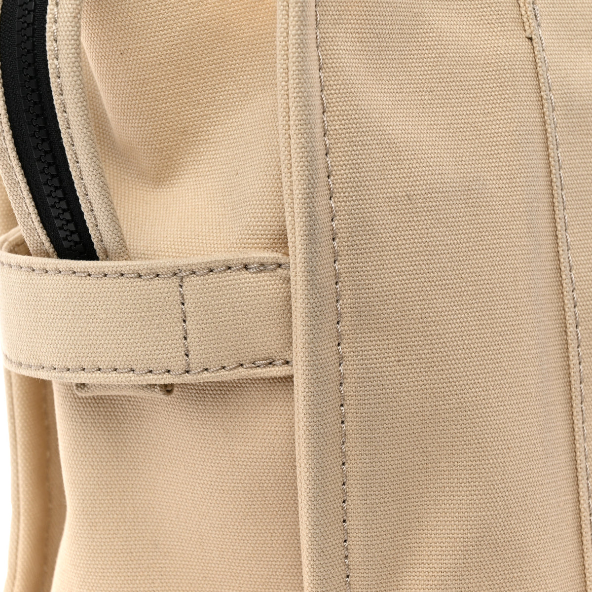 Close-up of the canvas weave, seam and zipper on a Marc Jacobs The Tote Bag.