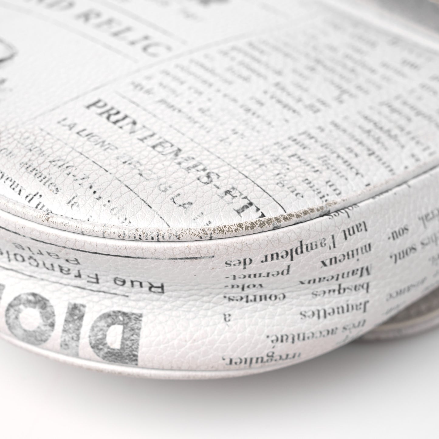 X DANIEL ARSHAM Grained Calfskin Newspaper Print Saddle Bag White