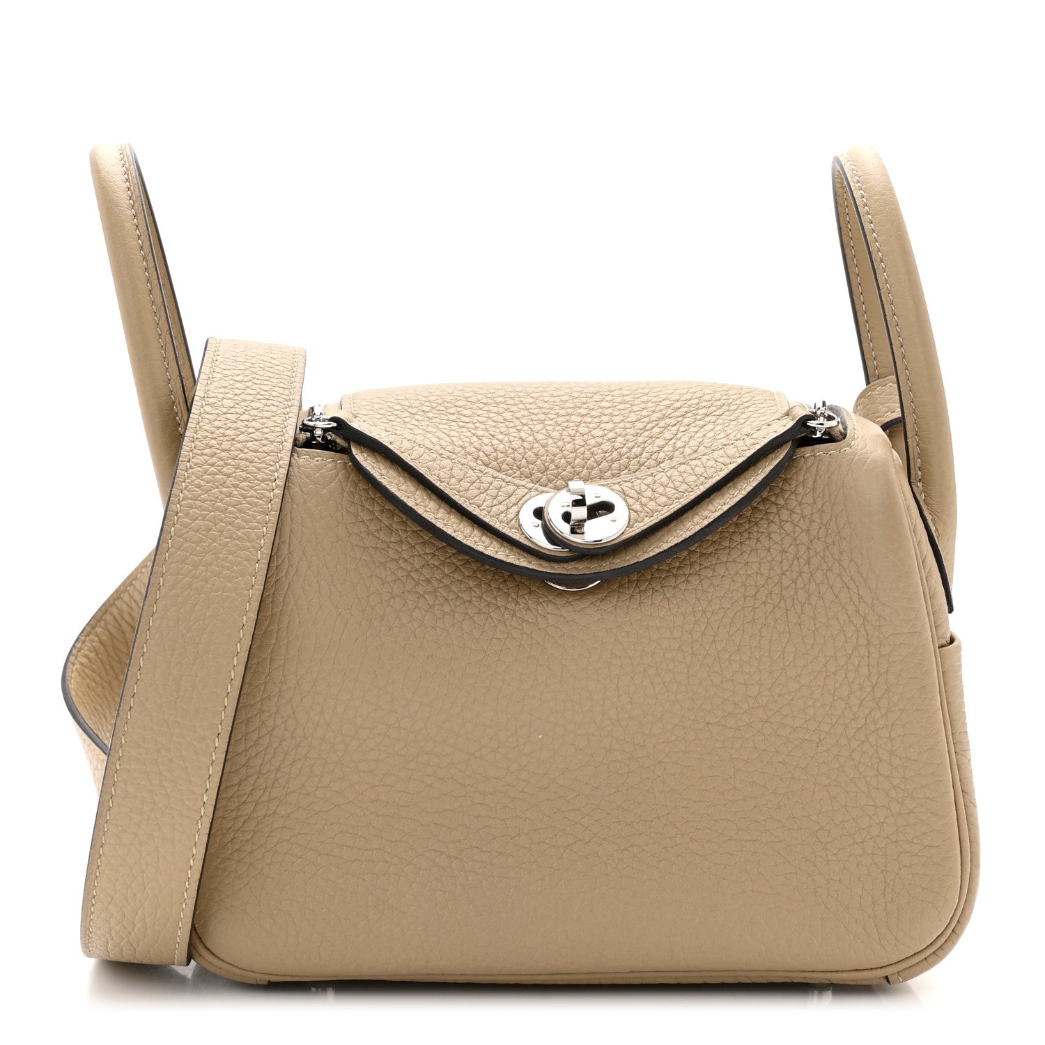 A photo of a tan HERMES Taurillon Clemence Mini Lindy 20 in Trench from FASHIONPHILE
