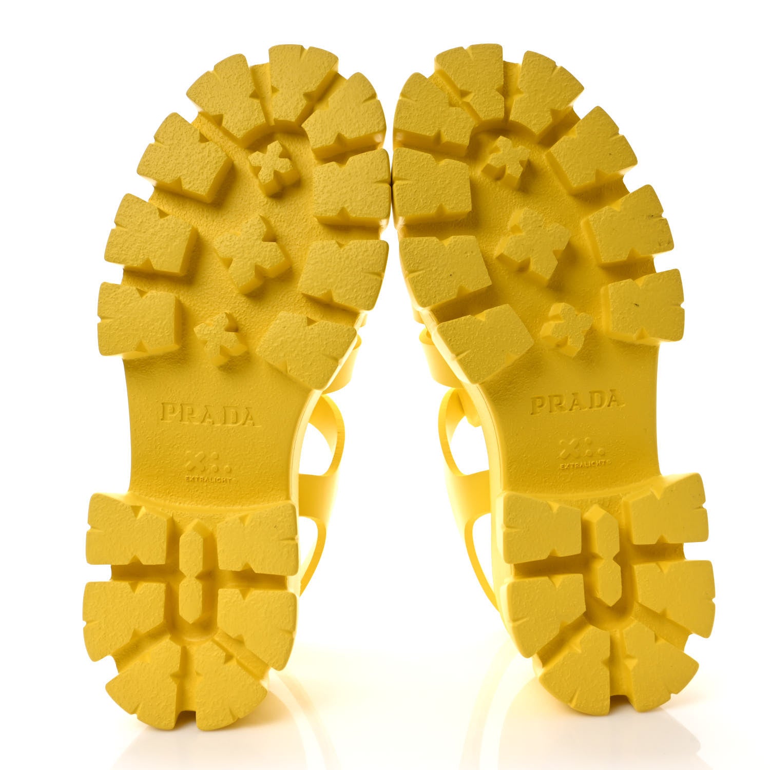Bottom view of a pair of yellow Prada rubber cage sandals revealing the sole by FASHIONPHILE
