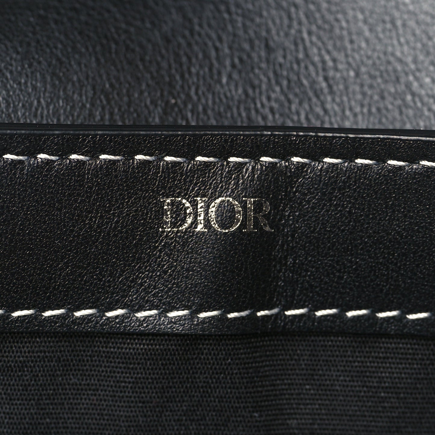 X KAWS Grained Calfskin Saddle Wristlet Black