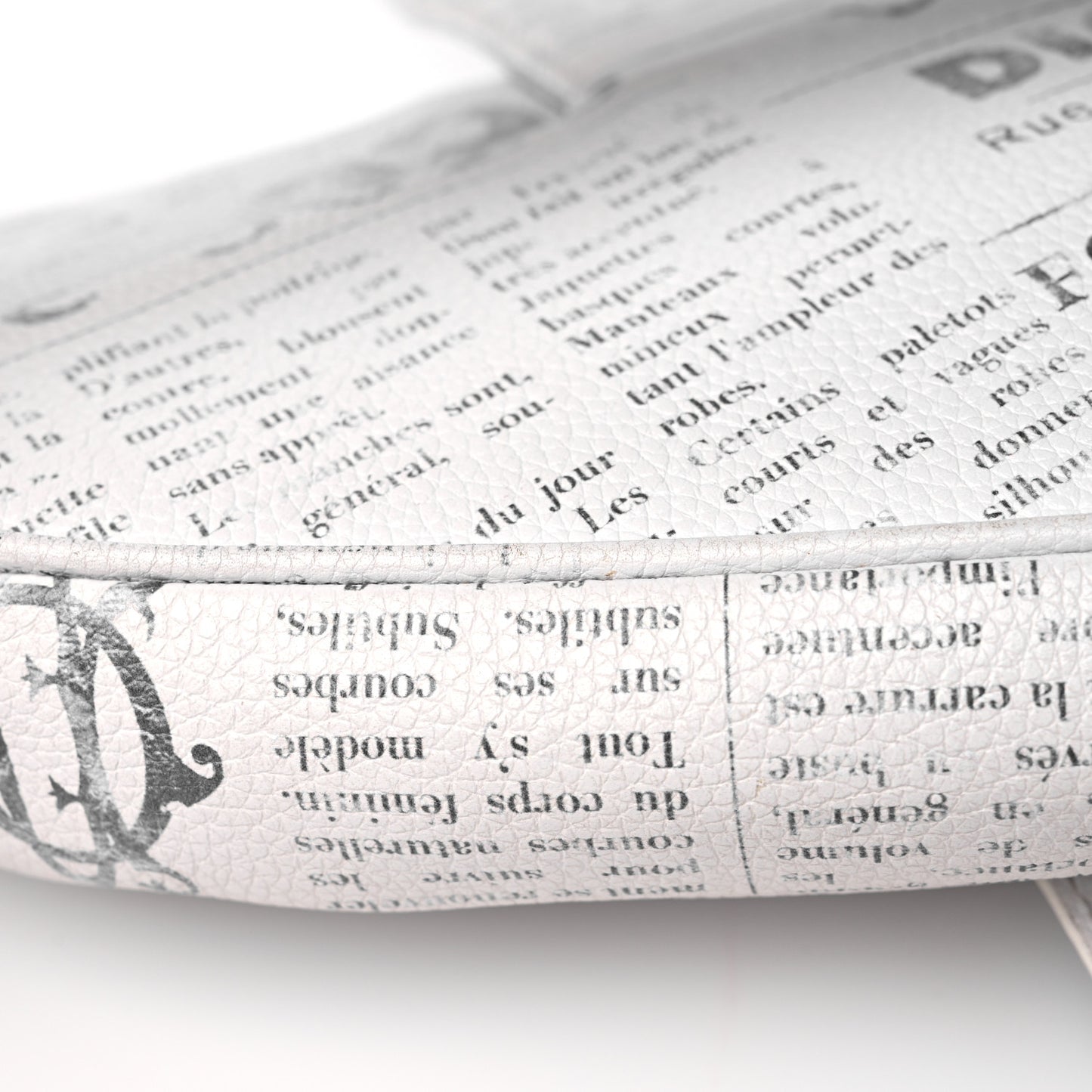 X DANIEL ARSHAM Grained Calfskin Newspaper Print Saddle Bag White