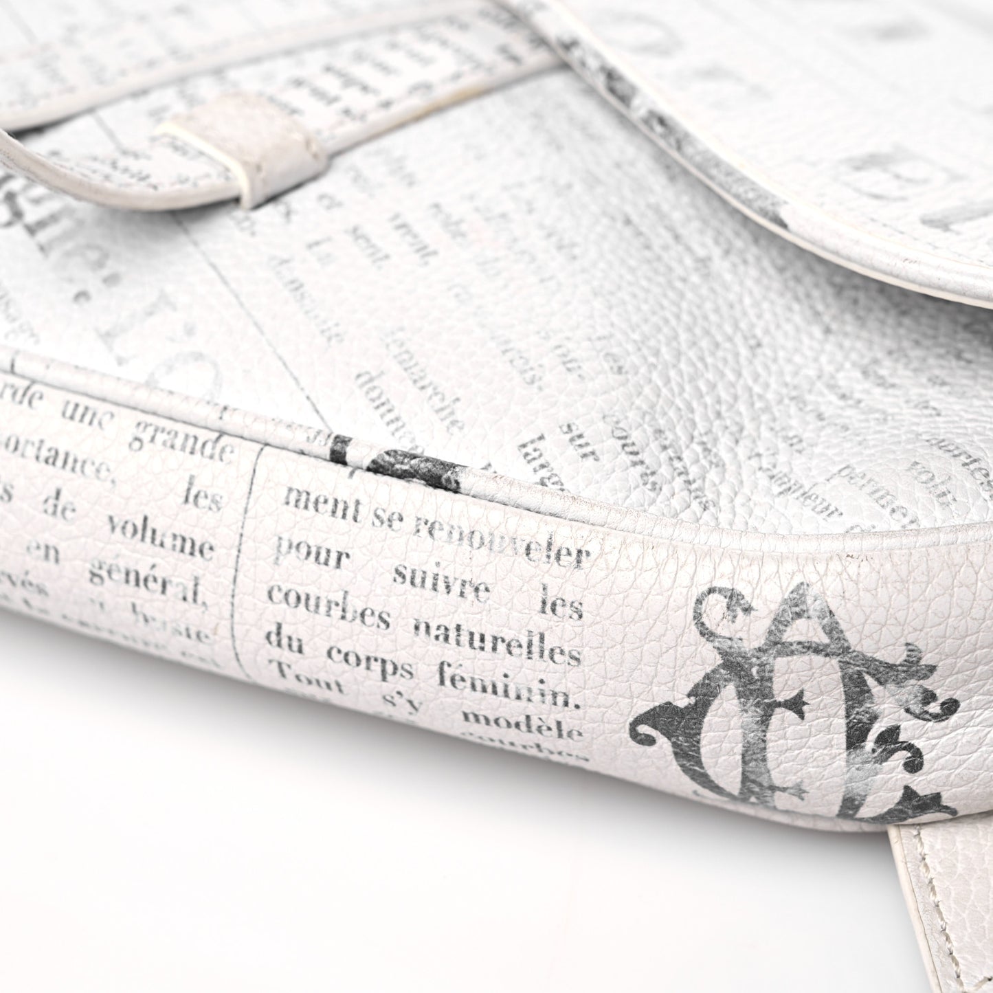 X DANIEL ARSHAM Grained Calfskin Newspaper Print Saddle Bag White