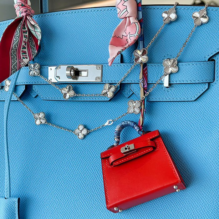accessorizing the birkin with van cleef and arpels jewelry, a bag charm, and a twilly scarf by FASHIONPHILE