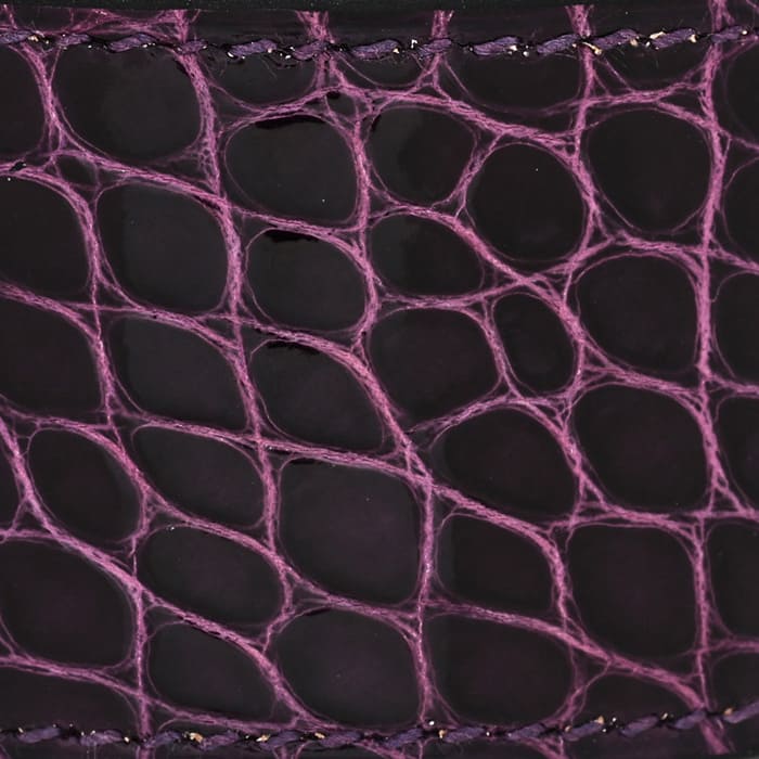 this is a close up swatch of hermes amethyst on shiny alligator leather by FASHIONPHILE