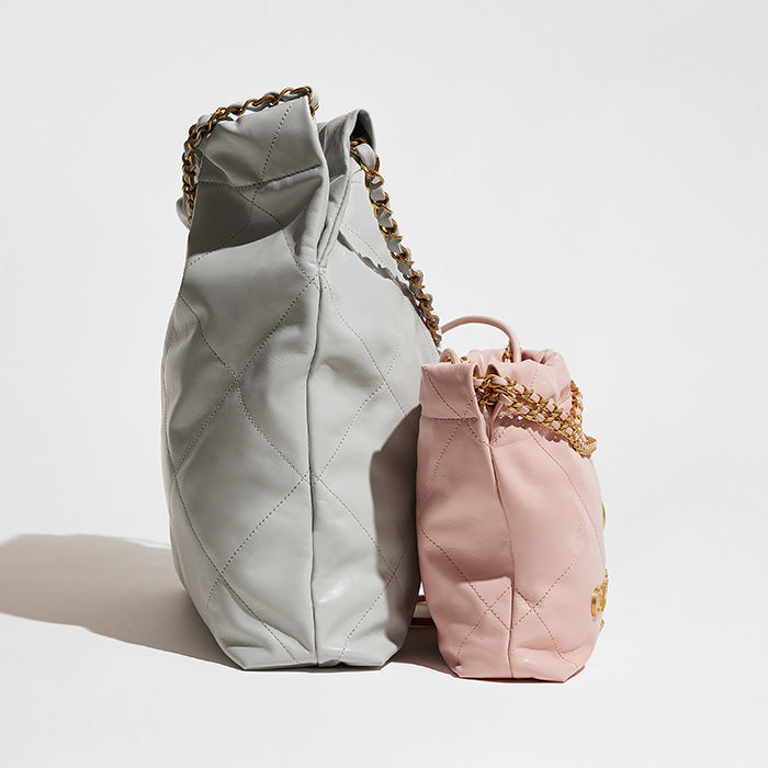 studio image of chanel 22 and mini chanel 22 bags side by side to compare size differences FASHIONPHILE