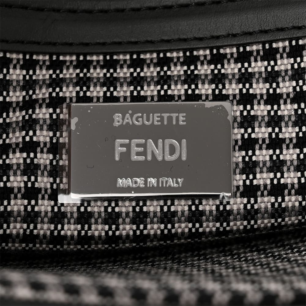 close up of authentic fendi baguette hardware logo plate at the interior of the bag by FASHIONPHILE