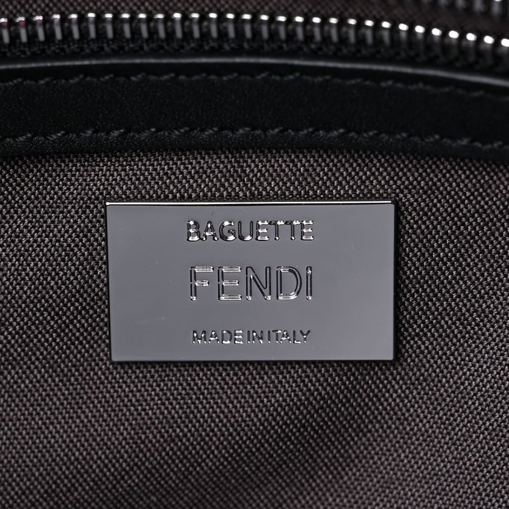 close up of fake fendi baguette hardware and font style at the interior of the bag by FASHIONPHILE