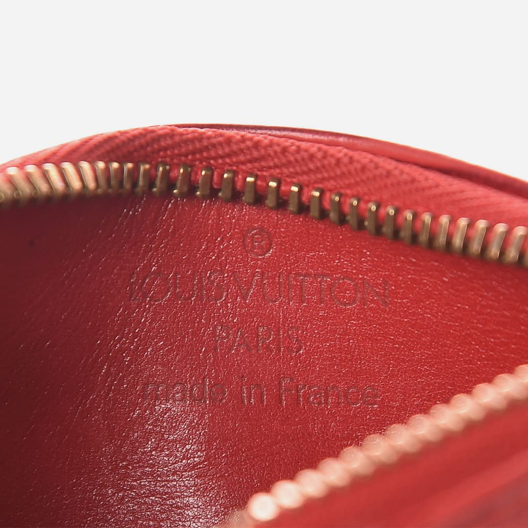 close up image of the interior of an authentic louis vuitton key pouch that shows the louis vuitton trademark stamp by FASHIONPHILE