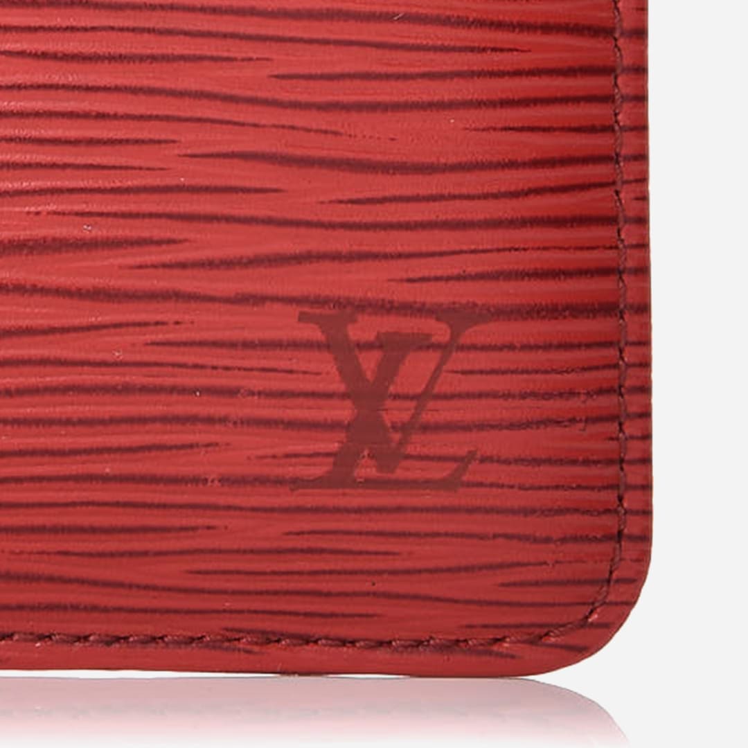 close up image of an authentic Louis Vuitton logo debossing at the lower right-hand corner of a Louis Vuitton Epi Leather Key Pouch by FASHIONPHILE