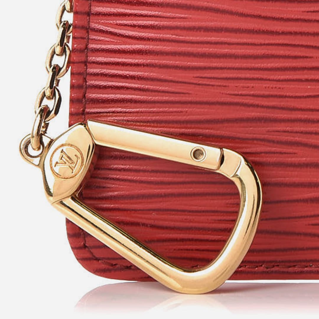 close up image showing the hardware on an authentic louis vuitton key pouch by FASHIONPHILE