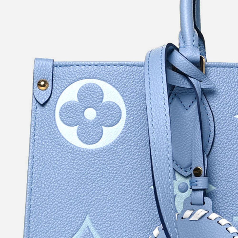close up image of authentic louis vuitton onthego tote in the color blue by FASHIONPHILE