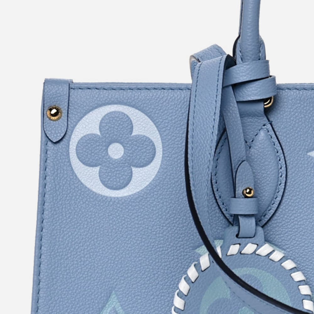 close up image of fake louis vuitton onthego tote in the color blue by FASHIONPHILE